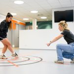 Fysiotherapeut begeleidt patiënt tijdens oefentherapie Fysiotherapeut begeleidt patiënt tijdens oefentherapie